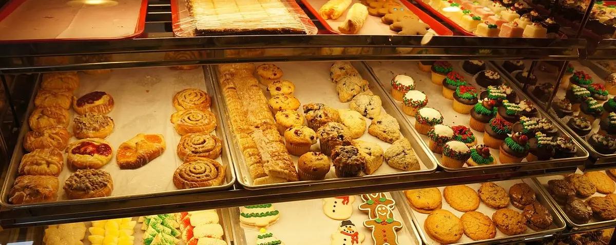 A bakery case of croissants, muffins, scones, and pastries (stock photo)